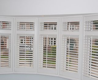 Bay window interior white shutters