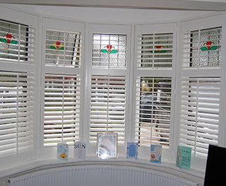 Bay window shutters in dining area